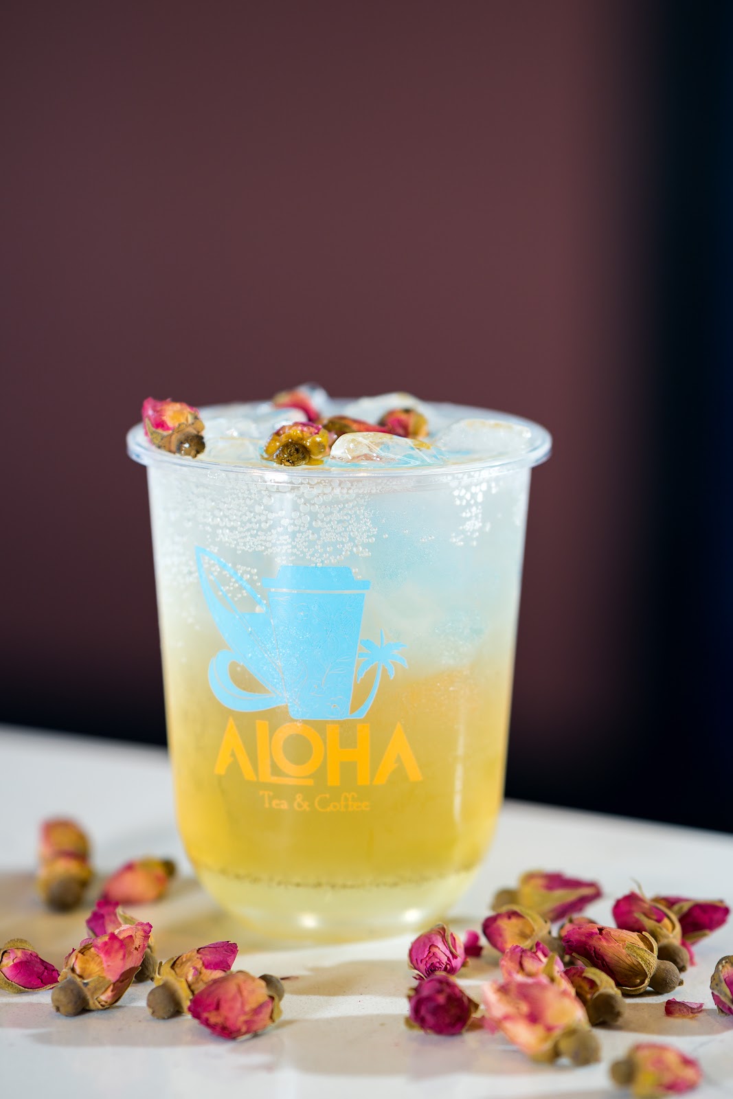An iced rose tea in an Aloha Tea Coffee cup